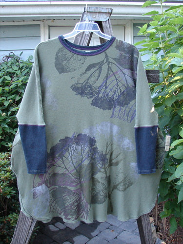 Barclay Thermal Contrast Revival Top Dried Floral Army OSFA on a hanger, showcasing long sleeves with ribbed accents, a rounded neckline, and a floral pattern.