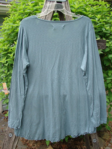 Barclay Modal Long Sleeved A Lined Tee Promo Field Dusky Sky Size 0, displayed on a hanger over a garden ladder, showcasing its lightweight slubbed modal cotton blend and A-line silhouette.