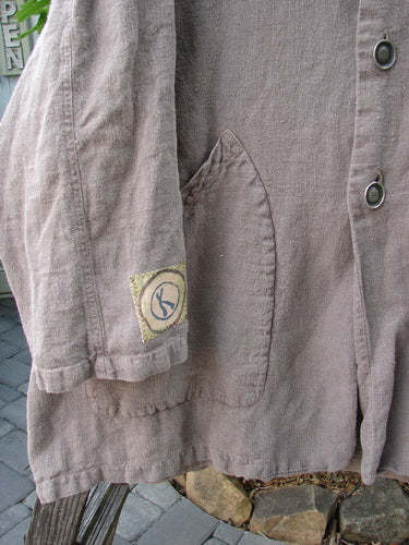 Close-up of the 1999 PMU Single Patch Hemp Yard Coat, featuring heavy-weight cotton hemp fabric, soft flannel inner lining, thick metal buttons, and triangular front pockets.