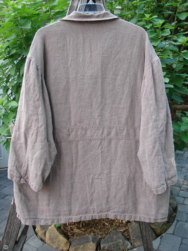 Alt text: The 1999 PMU Single Patch Hemp Yard Coat Shale Size 2 on a hanger, showcasing its heavy-weight cotton hemp outer, metal buttons, and triangular painted pockets.