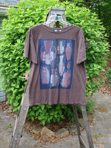 Barclay Short Sleeved Fiona Straight Tee Modern Vase Redwood Size 0 displayed on a rustic ladder, showcasing its unique vase-print design and the relaxed, generous cut against a natural outdoor backdrop.