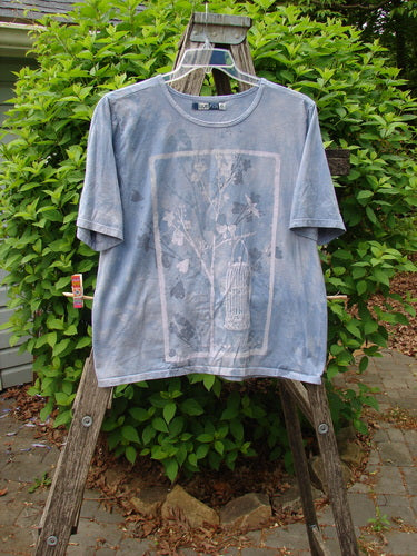 Barclay Fiona Crop Straight Tee in Victorian Mottled Bluestone, size 0, hangs on a ladder, showcasing its short sleeves and botanical graphic, reflecting Bluefishfinder.com's vintage-inspired, expressive style.