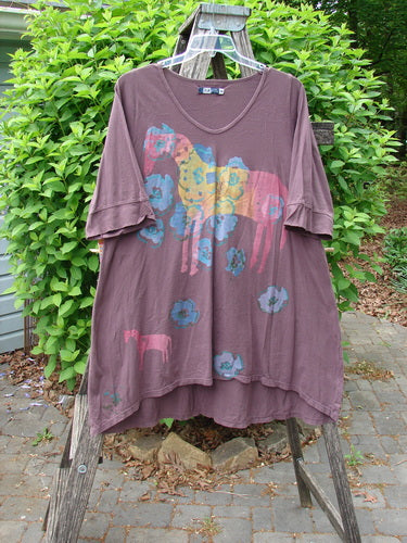 Barclay Three Quarter Sleeved Happiness Tunic Primitive Pony Fig Size 0, features a scoop-neck, faded multicolored elephant and floral print, displayed on a wooden A-frame outdoors, embodying Bluefishfinder.com's vintage, expressive style.