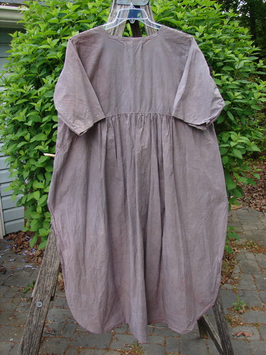 Barclay Percale Key Pocket Hi Low Dress Floral Burst Mocha Size 0 features a loose fit, gathered waist, key neckline, and dual elastic-topped pockets, displayed on a hanger against a rustic backdrop.