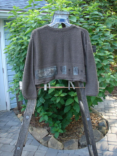 1994 Crop Cardigan Sweater Topiary Humus OSFA displayed on a wooden ladder with clothes pegs, showcasing its intricate textures, stoneware buttons, and cozy long sleeves.
