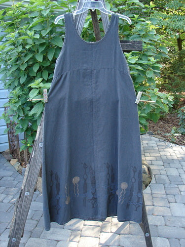 2000 Tencel Shift Dress Biology Abstract Twilight Size 0 displayed on a wooden ladder, showcasing the buttery soft chambray fabric with an abstract hem design and a downward curved empire waist seam.