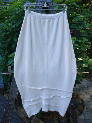 Barclay Thermal Awen Skirt Unpainted Crème Size 0 hanging outdoors, showcasing its unique bell shape, textured diagonal hemline, and full elastic waistband, highlighting the vintage style of BlueFishFinder.com.