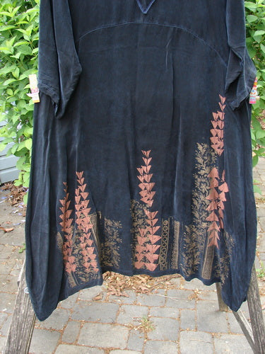 Barclay Cupro Cross Over Urchin Dress Floral Reach Metallic Black Evening Size 0 draped over a wooden frame, showcasing its luxurious cupro fabric, cross over neckline, and distinctive metallic floral motifs.