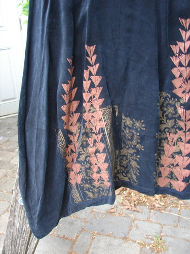 Barclay Cupro Cross Over Urchin Dress showcases a navy or black fabric with a muted pink botanical print and gold border along the hem, capturing Bluefishfinder.com's vintage elegance.