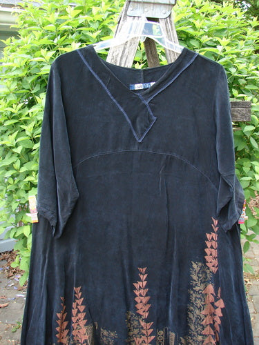 Barclay Cupro Cross Over Urchin Dress Floral Reach Metallic Black Evening Size 0: A loose-fitting black dress with orange botanical print, three-quarter sleeves, and a variable hemline, hanging outdoors from a wooden ladder.