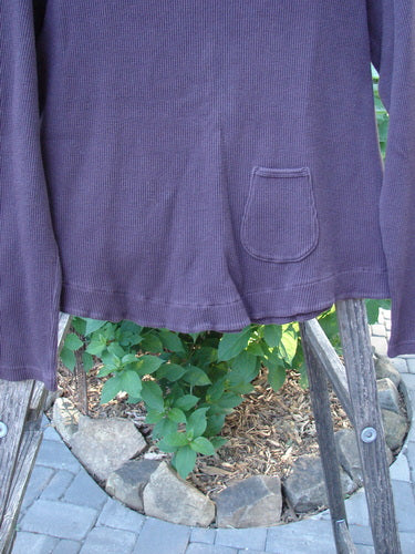 Barclay Patched Thermal Tuck Top Raisin Size 1 displayed on a chair, highlighting its rounded neckline, longer sleeves, and unique teacup patch at the rear upper center.