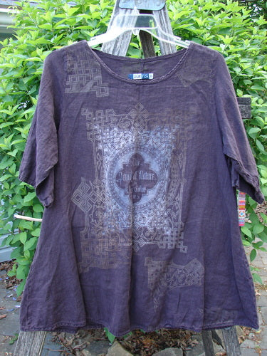 Barclay Linen A Line Top London 1844 Deep Burgundy Size 0, featuring elbow-length sleeves and a geometric motif with Our Father text, displayed on a hanger against a natural backdrop.