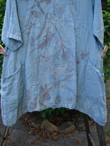 Barclay Linen Urchin Dress Leaf Floral Dusky Watercolor Size 1, featuring a loose fit with an empire waist, elbow-length sleeves, and floral print, displayed outdoors among greenery, embodying Bluefishfinder.com's vintage aesthetic.