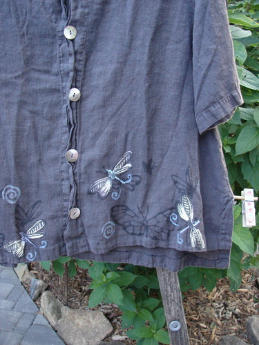 Close-up of 1999 Handkerchief Camp Shirt Dragonfly Raven Altered Size 1, highlighting the dragonfly-themed paint, signature patch, and shell buttons on lightweight linen fabric.