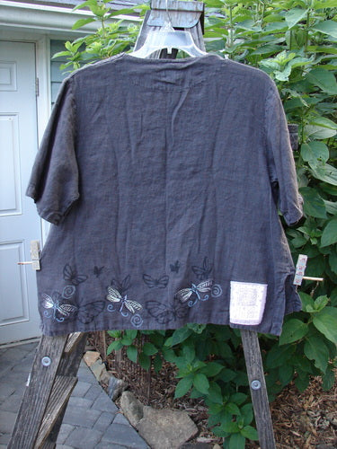 1999 Handkerchief Camp Shirt Dragonfly Raven Altered Size 1 featuring butterfly prints, A-line shape, shell buttons, and vented sides, modeled by a person with a blurred arm in the frame.