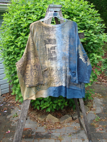 Barclay Writer's Pocket Pullover Future Night to Day OSFA draped over a wooden ladder, showcasing its abstract graphics and seamless design, highlighting a rounded neckline and dual pockets.