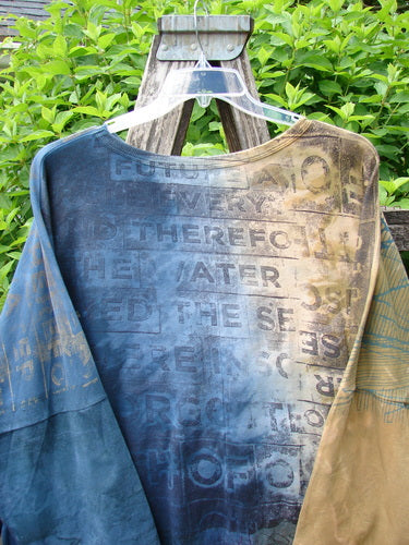 Barclay Writer's Pocket Pullover Future Night to Day OSFA, showcasing a seamless, tie-dye design, hangs on a ladder. Features include faded text and unique dual drop pockets, embodying Bluefishfinder.com's creative, vintage style.