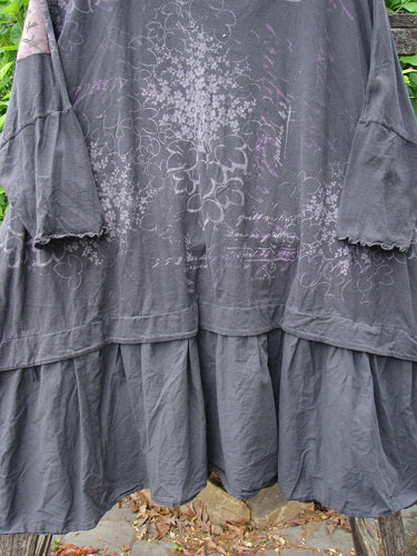 Barclay Patched Batiste Banded Flounce Esperanza Tunic Floral Storm OSFA features a loose fit, tiered ruffled hem, ¾-length bell sleeves, and faint floral-text print, embodying Bluefishfinder's vintage charm.