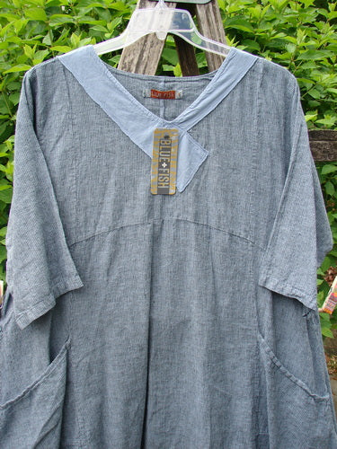 Barclay NWT Linen Cross Over Urchin Dress Unpainted Stripe Sky Size 1, featuring a loose fit, V-neckline with solid yoke, elbow sleeves, and side pockets, displayed on a hanger outdoors.