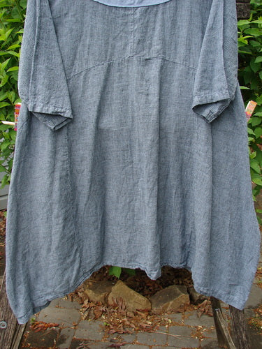 Barclay NWT Linen Cross Over Urchin Dress, Unpainted Stripe Sky Size 1, hanging outdoors, showcases a knee-length design with ¾-length sleeves, a V neckline, and double drop flop side pockets.