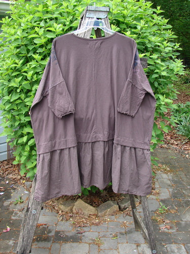 Barclay NWT Batiste Banded Flounce Esperanza Tunic Festive Garden Sparrow OSFA displayed on a wooden ladder, showcasing its tiered skirt, dolman sleeves, and rounded neckline, highlighting BlueFishFinder's vintage-inspired style.