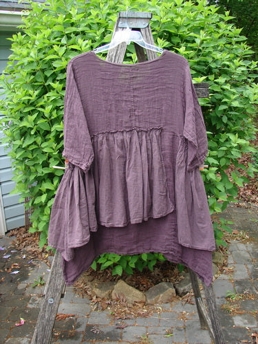 Barclay Gauze Batiste Petal Urchin Flounce Dress Unpainted Fig Size 1, draped on a ladder, features a gathered peplum waist, uneven hem, and three-quarter sleeves, showcasing Bluefishfinder's vintage creativity.