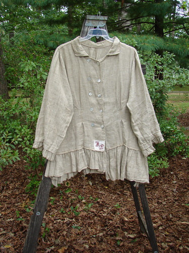 Magnolia Pearl Homespun Linen Double Breasted Curve Jacket displayed on a hanger, showcasing its collared neckline, double-breasted front, vertical pleats, gathered hem, and three-tiered back with signature Love Patch.