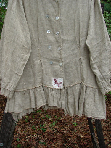 Magnolia Pearl Homespun Linen Double Breasted Curve Jacket features a rounded collar, double-breasted buttons, vertical pleats, gathered ruffled hem, and cuffs, with a tiered back and signature Love Patch.