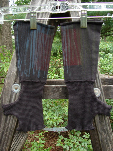 Barclay Cotton Lycra Thermal Fingerless Forearm Glove in Black, displayed on a wooden ladder, showcasing its waffle thermal hand section and unique thumbholes.