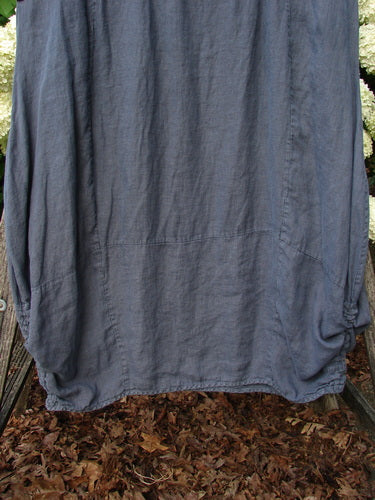 Bluefishfinder.com Barclay Linen Draw Bottom Urchin Dress in unpainted dusty navy, size 0, with a loose linen drape and gathered draw bottom. The softly textured fabric falls in a straight front panel with rounded side seams, framed by muted blue-gray folds.