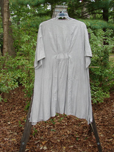 Barclay Light Weight Cotton High Vent Curve Dress in Grey Black Pinstripe, featuring three-quarter sleeves, side vents, and a sweeping A-line shape, displayed on a clothes rack.