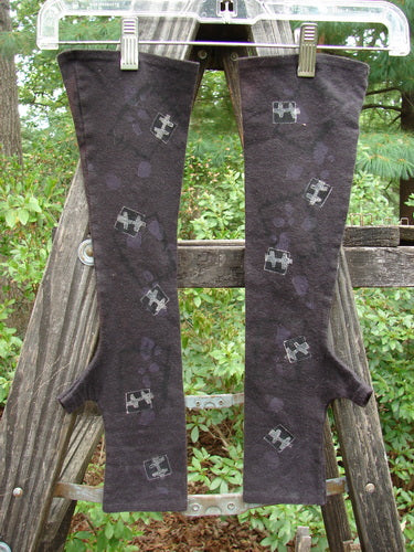 Barclay Cotton Lycra Hemp Fingerless Glove Flower Window Plum OSFA displayed on a wooden ladder outdoors, highlighting flattened edgings, four finger opening, thumb tunnel, and flower window theme.