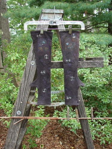 Barclay Cotton Lycra Hemp Fingerless Glove Flower Window Plum OSFA displayed on a wooden ladder outdoors, showcasing its cozy fit and unique design elements.