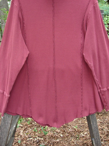 Close-up of the Barclay Thermal Reverse Stitch Tunnel Pocket Top in Burgundy, showcasing the curly-edged floppy turtleneck and center front kangaroo tunnel pocket.