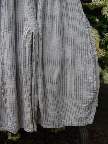 Bluefishfinder.com Barclay Gauze Crop Mojo Pant in unpainted sandy stripe, size 0, with a loose cropped silhouette and airy gauze texture. Fine vertical stripes and softly gathered leg volume are shown against leafy greenery, in muted gray-beige tones.