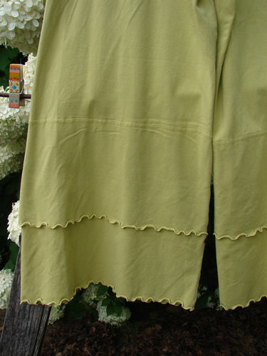 Bluefishfinder.com Barclay Cotton Lycra Crop 2 Petal Pantaloon in unpainted sunshine, size 0, shown as olive-yellow cropped pants with a soft cotton-lycra drape and scalloped petal hems. The layered fabric falls in a loose, textured silhouette, with the hemline filling the frame.