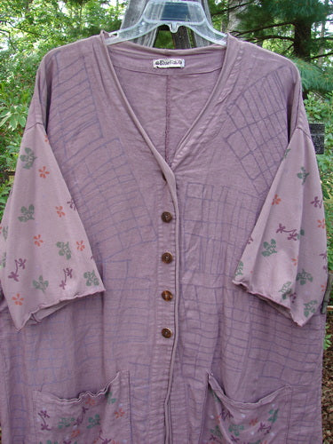 Barclay Linen Cotton Sleeve Pocket Cardigan in Rich Mauve, featuring a curved front with wooden buttons, floral-themed drop shoulders, and matching lower squared pockets.
