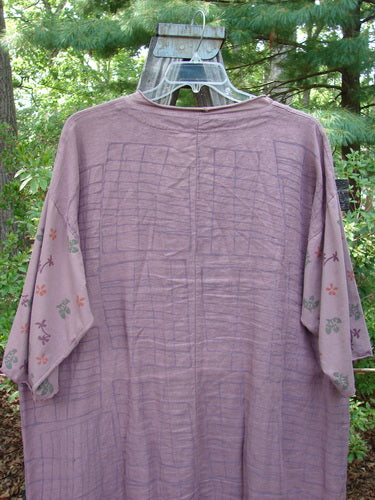 Barclay Linen Cotton Sleeve Pocket Cardigan in Rich Mauve, featuring a curved front with wooden button, deep V-neck, drop shoulders, floral-themed organic cotton sleeves, and matching lower pockets.