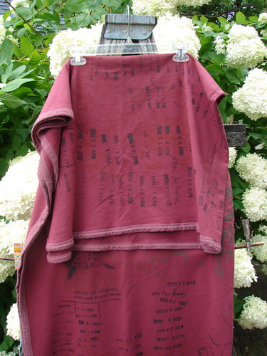 Bluefishfinder.com Barclay Heavy Weight Organic Sweatshirt Blanket Owl Forest Trimmed Burgundy OSFA, a burgundy sweatshirt-style blanket with dark printed graphics, draped in layered folds over a wooden chair. The heavy organic fabric shows a soft, brushed texture and a trimmed edge, set against white hydrangea blooms and green foliage.