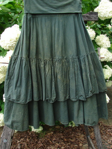 Bluefishfinder.com Barclay Linen Fold Over Two Tier Trinity Skirt in mottled army green, a layered linen skirt with a folded-over waistband and two tiered, softly gathered panels. The textured fabric falls in a full, draped silhouette with a muted matte finish.