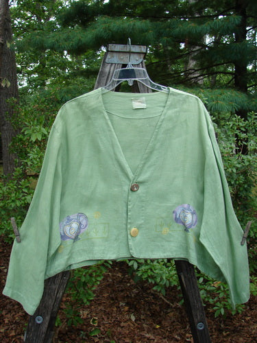 1999 Weathervane Jacket Tea Heart Spearmint Size 2 displayed on a hanger, featuring mix-match buttons, inward rounded side hem, and hand-painted tea and heart design.