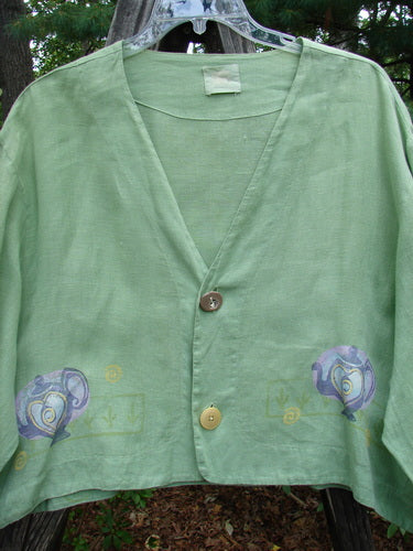 1999 Weathervane Jacket Tea Heart Spearmint Size 2 features a green shirt with an elephant design, two front mix-match buttons, a varying inward rounded hem, and a deep V-shaped neckline.