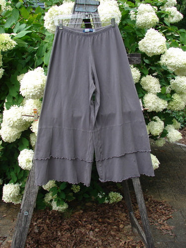 Bluefishfinder.com Barclay Cotton Lycra Crop 2 Petal Pantaloon in unpainted dusty plum, size 0, hangs from a wooden ladder against white hydrangeas. The cropped cotton-lycra pants have a soft drape, wide legs, and scalloped petal hems.
