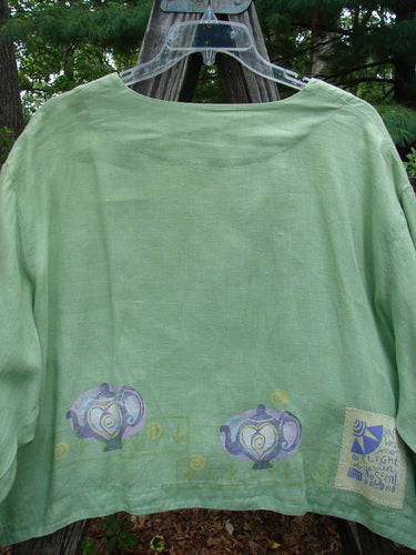 1999 Weathervane Jacket Tea Heart Spearmint Size 2, featuring teapot and heart designs, unique front mix-match buttons, a rounded side hem, and a deep V neckline in lightweight linen.