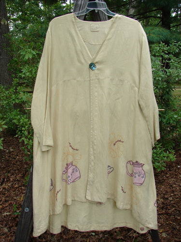 1999 Cream and Sugar Coat Pitcher Plantain OSFA: A white linen coat adorned with teapots and teacups, featuring a V-neckline, upward scoop front hem, deep side pockets, and an oversized shell button closure.
