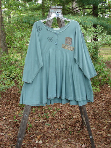 1994 Juniper Dress Swirl Leaf Sea Journey Size 2 displayed on a hanger, featuring a wide rounded collar, sectional panels, and a full sweeping lower hem with vintage swirl and leaf patterns.