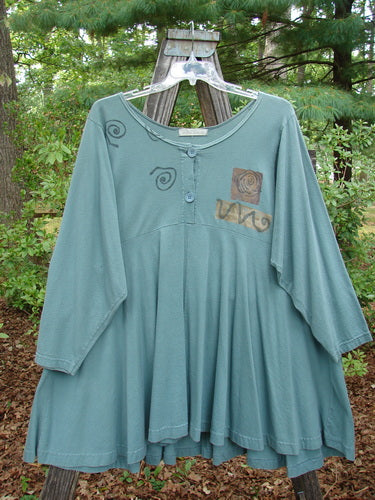 1994 Juniper Dress Swirl Leaf Sea Journey Size 2 displayed on a swing hanger, showcasing its rounded collar, vintage buttons, and curved empire waist seam.