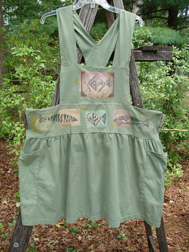 1995 Overall Jumper Fish Path Dinette Green OSFA with fish designs, oversized side pockets, crisscross back straps, and a gathered skirt, from Bluefishfinder.com's vintage collection.