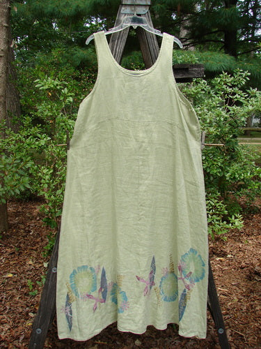 Barclay Linen Tank Dress Undersea Celery Size 2 displayed on a clothesline, showcasing medium-weight linen with a rounded neckline, curved empire waist seam, and sweeping lower skirt painted in an undersea theme.