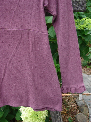 2000 Wool Pointelle Anais Top Unpainted Murple Tiny Size 0, featuring lettuce edging, empire waist seam, tailored waistline, and narrow lower sleeves, displayed on a clothesline.